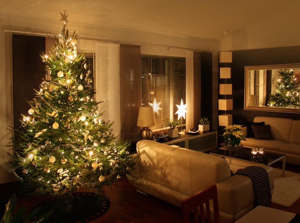 A photo of a living room with a lit up Christmas tree